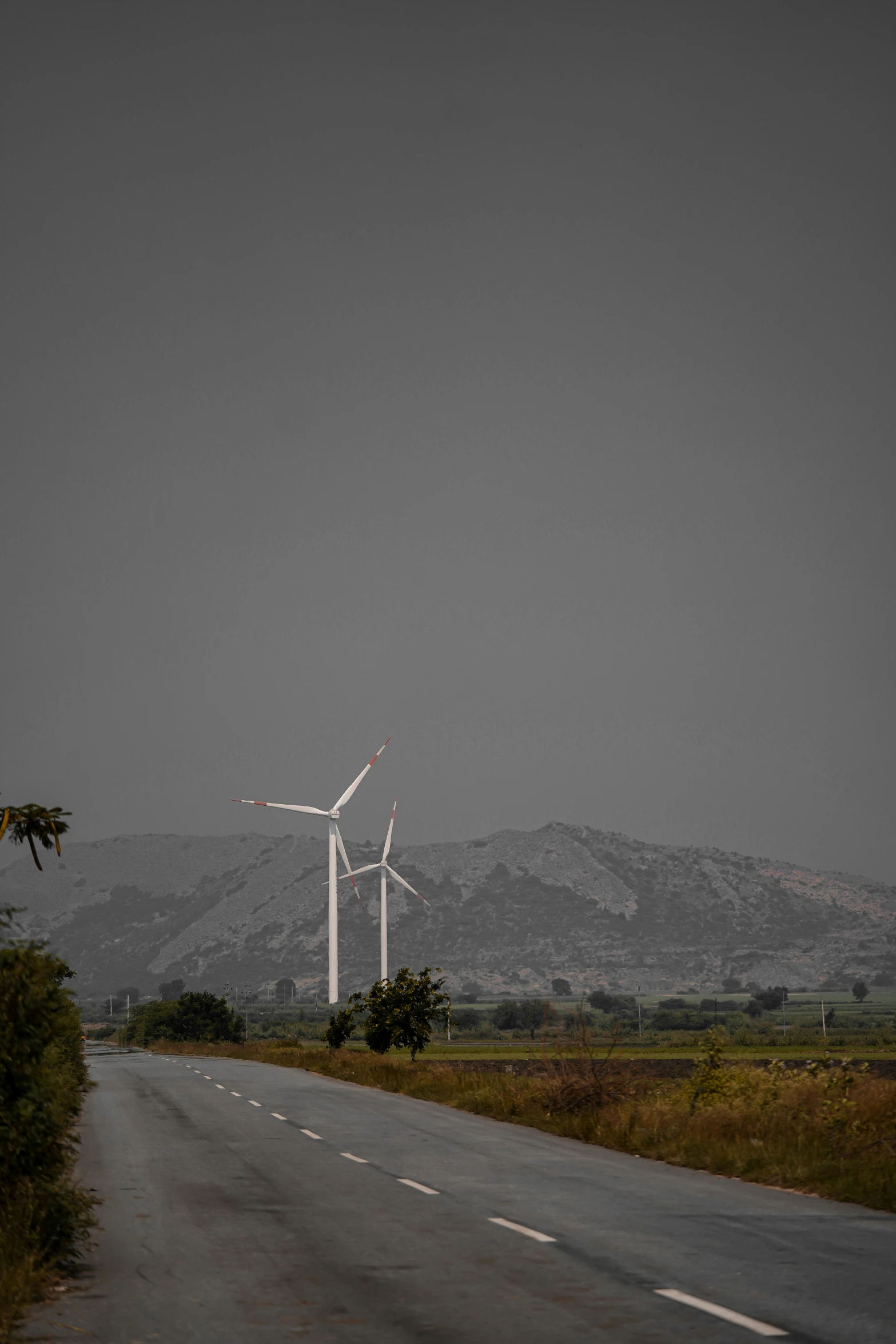 there are several wind turbines that can be seen on this street