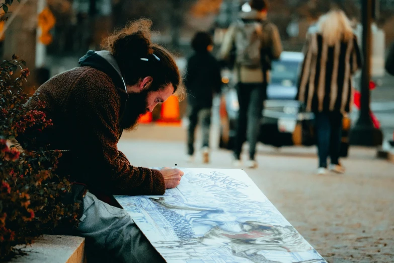 a person sitting on a bench and a street sign