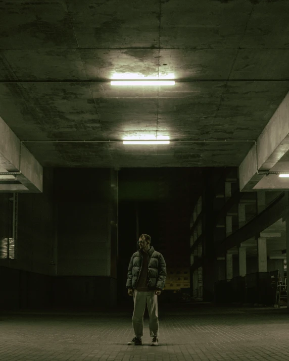 there is a man standing alone in a dark building