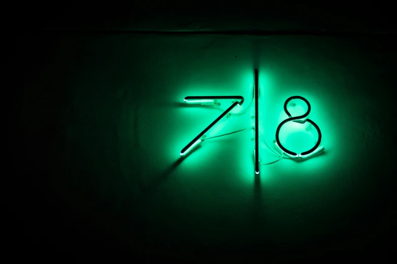 neon numbers on a wall and the lights are on