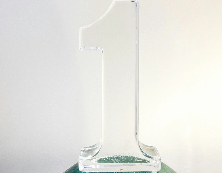 the large clear glass is standing on a blue base