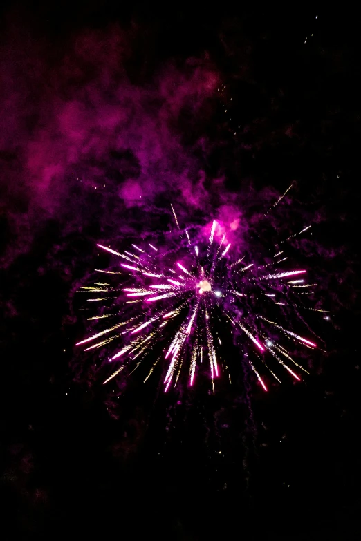 purple fireworks with some stars in the sky