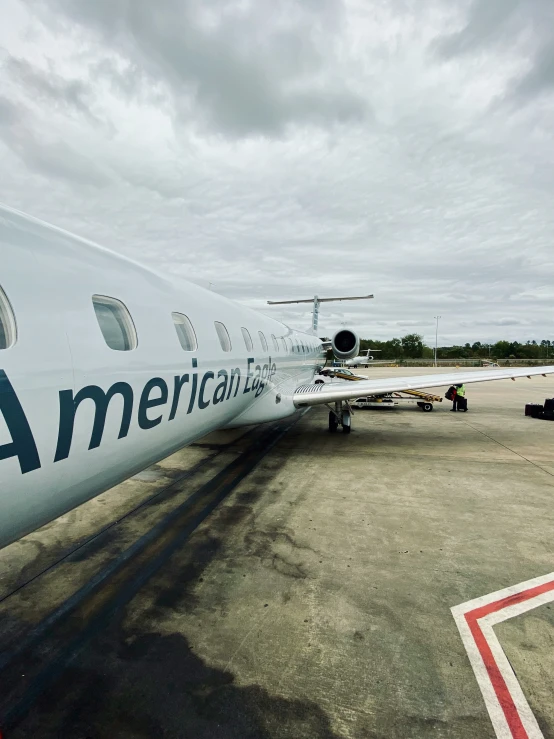 an american airlines passenger jet sits in the runway