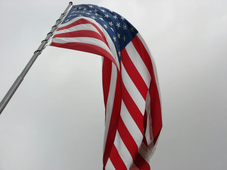 the american flag waving against a blue sky