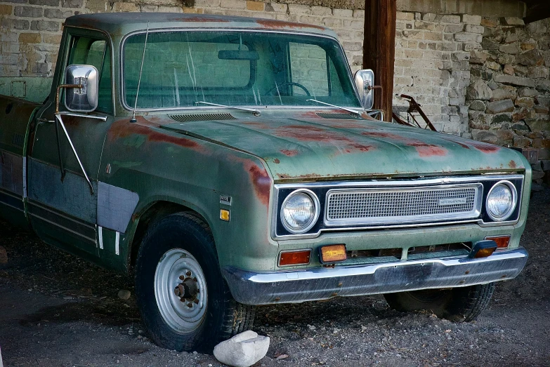 an old pick up truck parked outside of a building