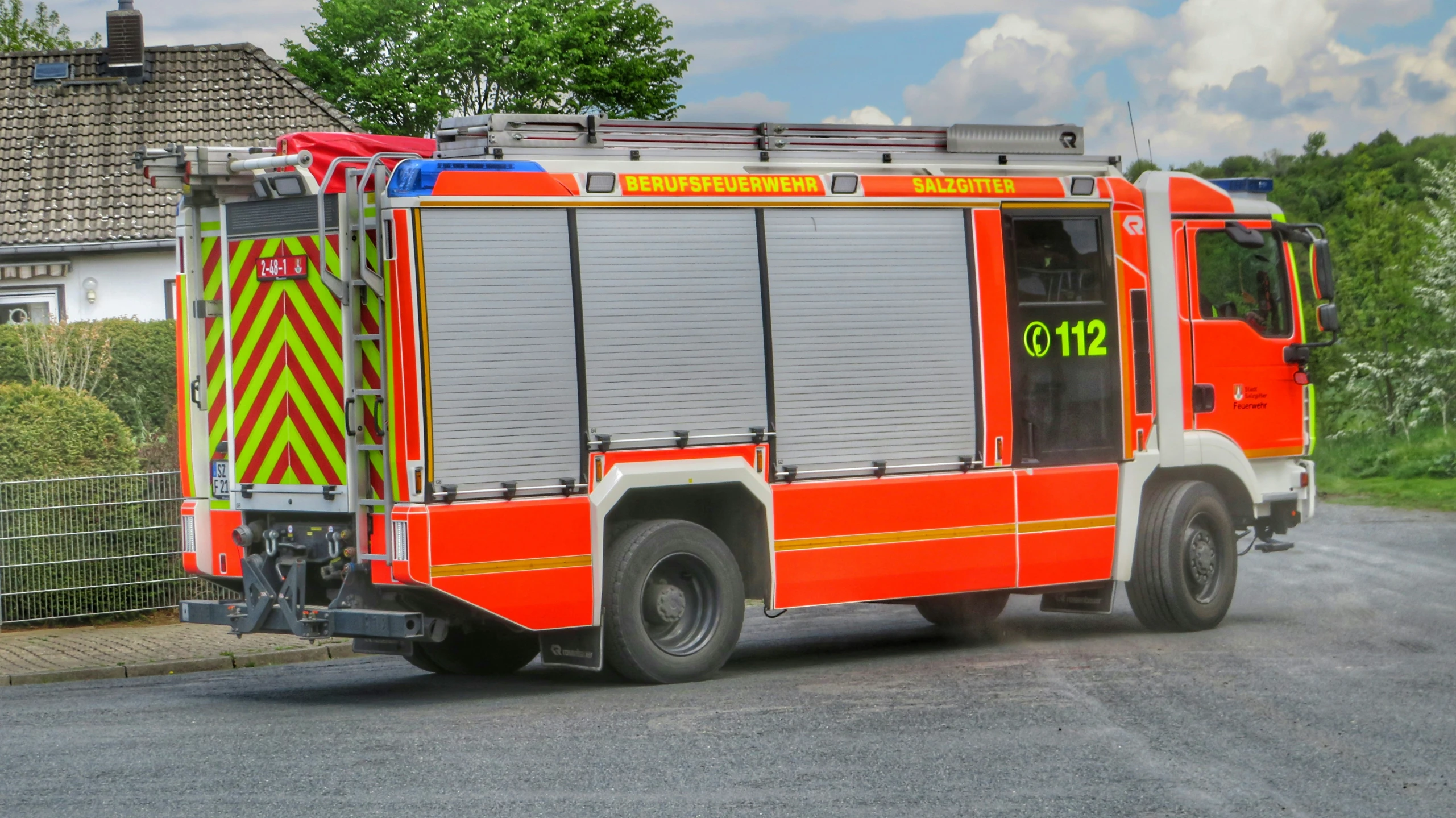 an orange and silver fire truck is shown