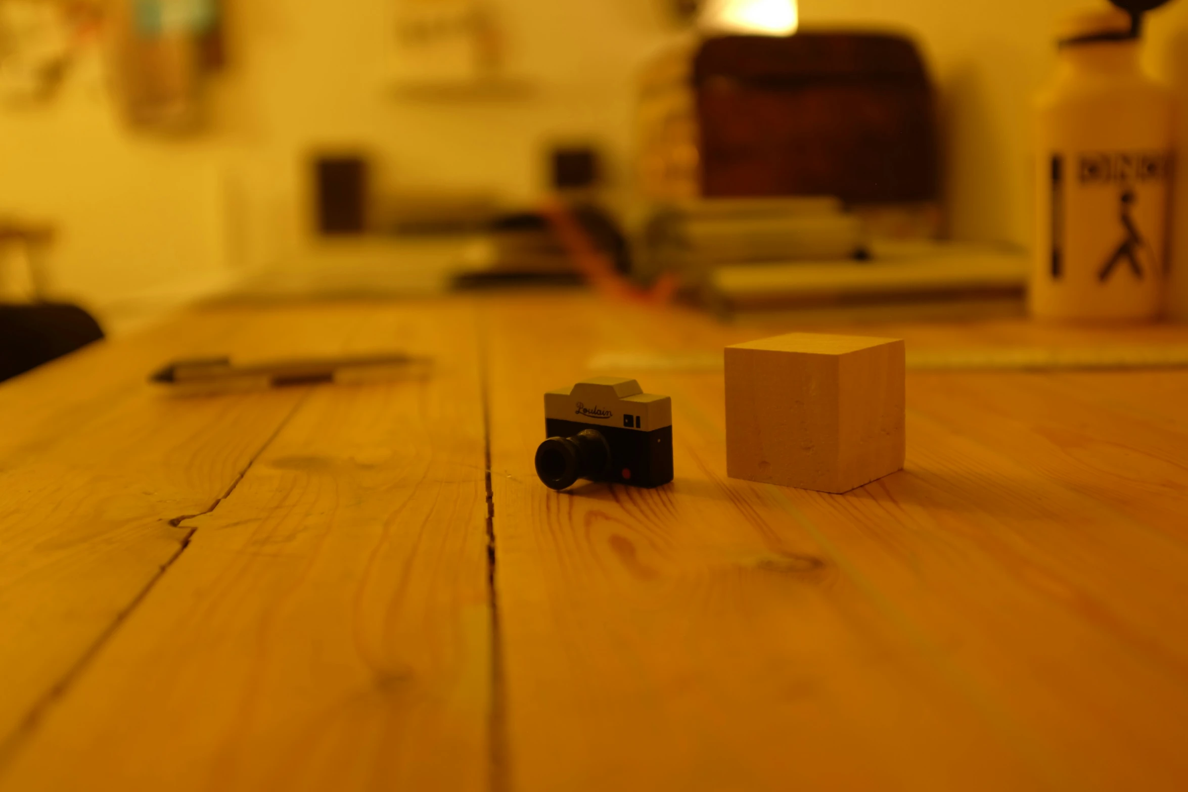 a wooden table topped with a toy camera