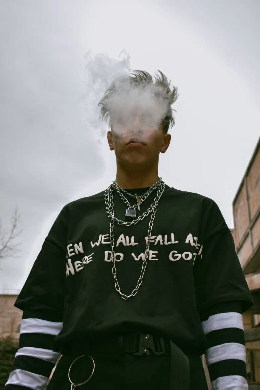 the man with smoke on his face stands outside in front of a building