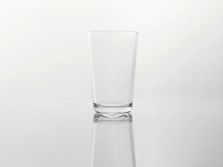 a glass with a reflection on a surface