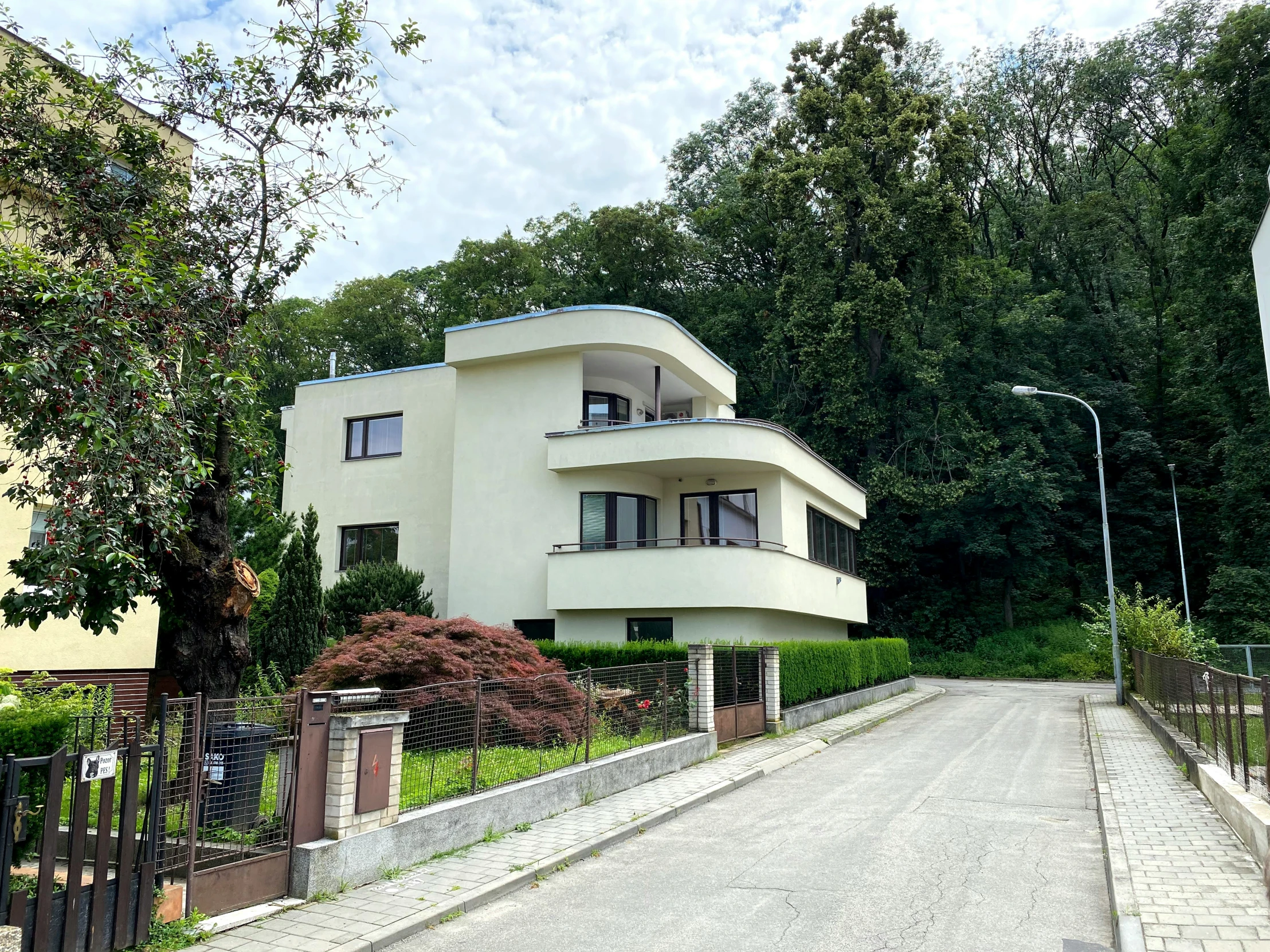 a large white house sitting on the side of a road