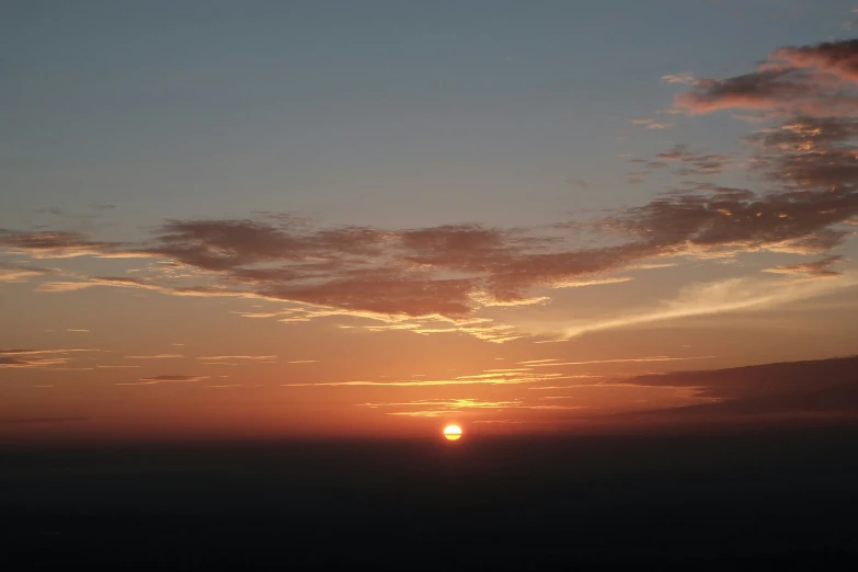 the sunset as seen from a jet liner