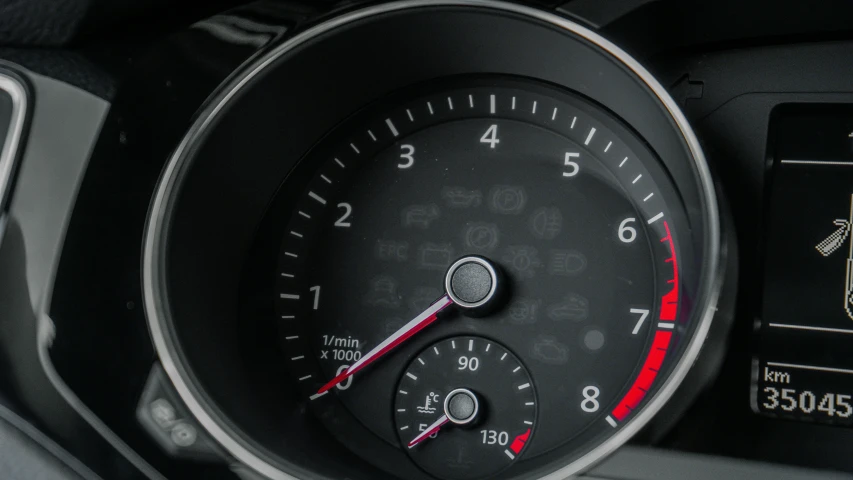 the dashboard of a small car with three different meters