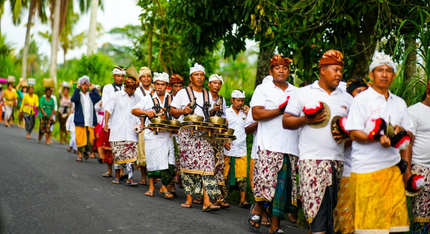 people lined up with hats and garlands on their heads