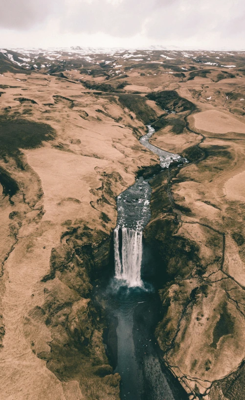 the view from a airplane looking down on a lake and a waterfall