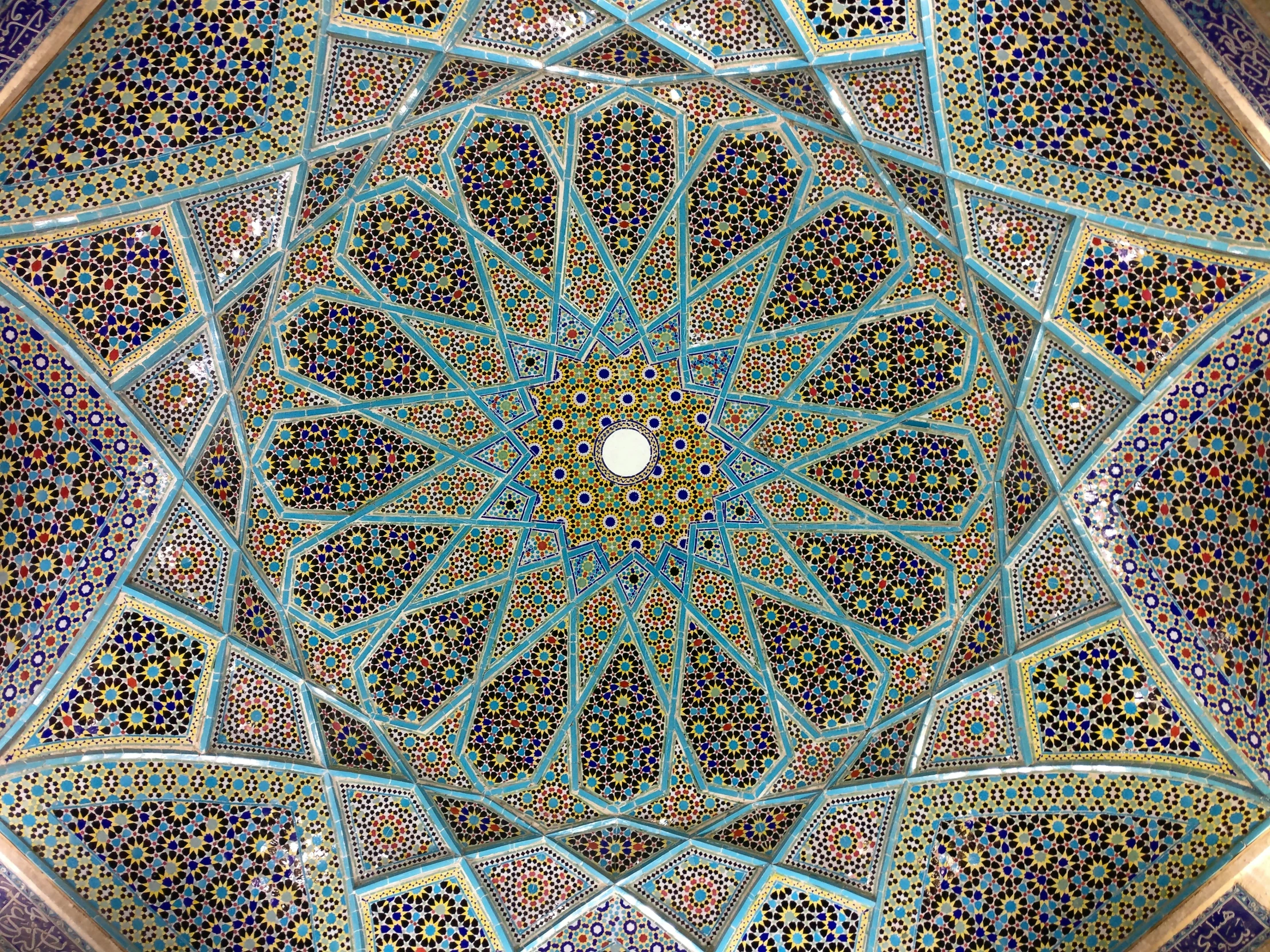 the roof of a building with blue and green details