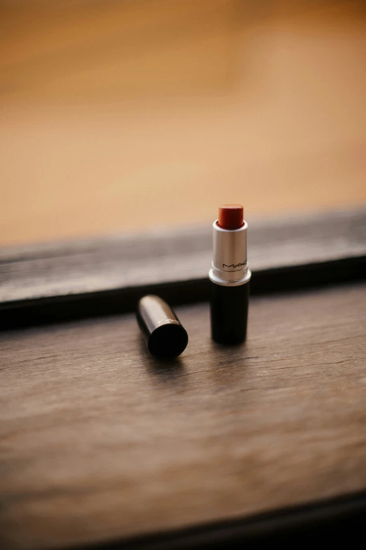 a lipstick on the ground on a table