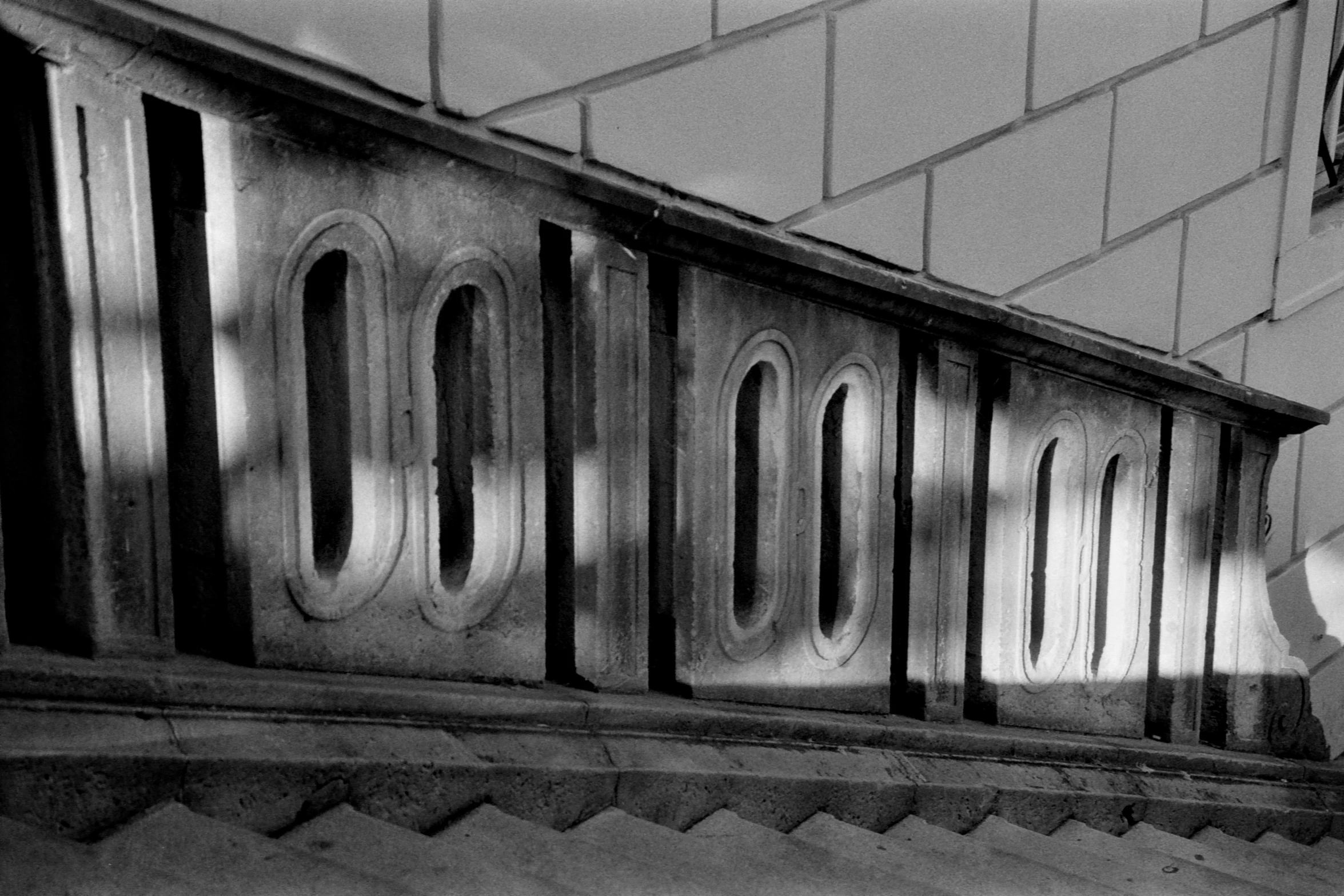 a man walks up an old metal railing