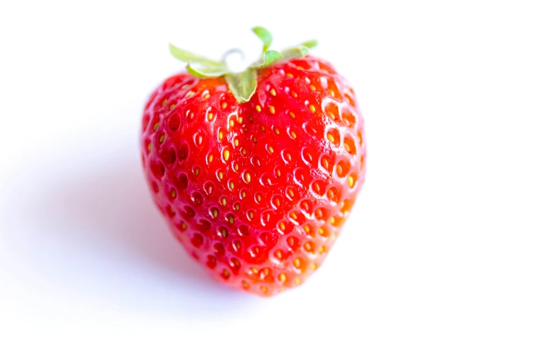 a closeup of a small red strawberry