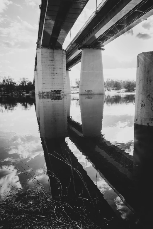 an old bridge spanning a river that crosses over the water