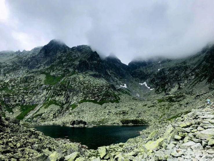 the large mountain is full of boulders and grass