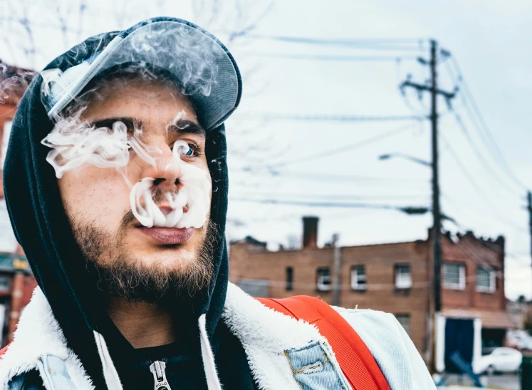 a man with a strange cigarette in his mouth