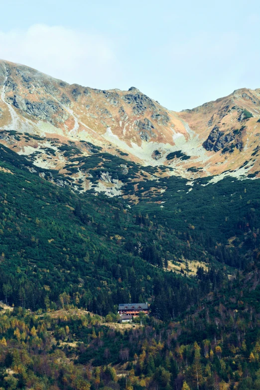 a house in the mountains surrounded by forest