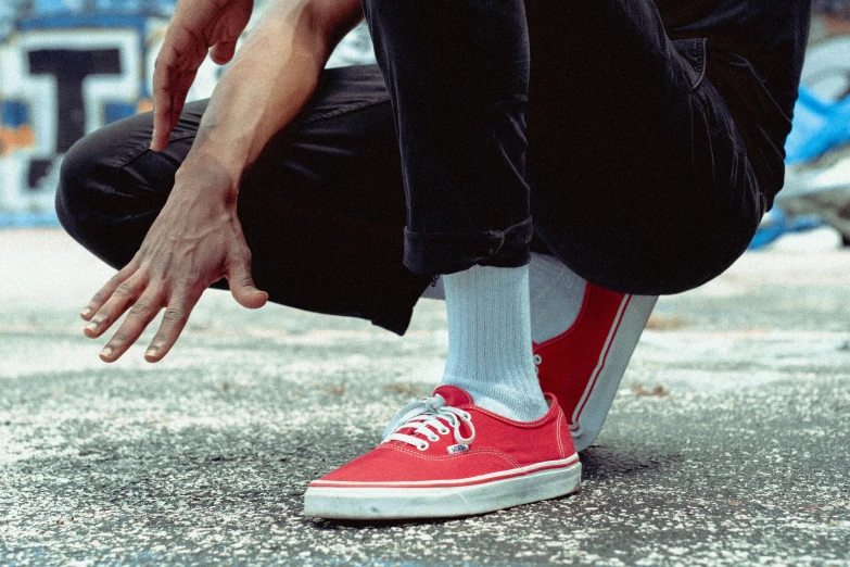 a person sitting on the ground touching their foot