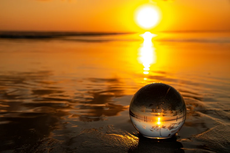 a picture of a very pretty sunset and a glass ball