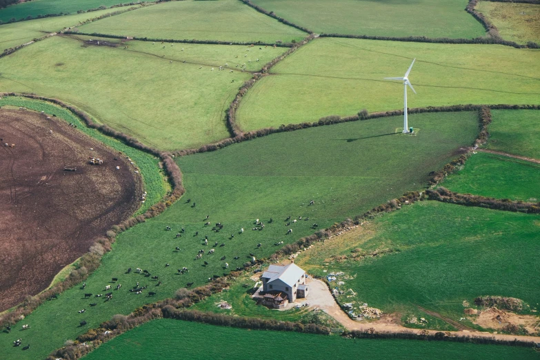 an aerial view of the countryside and wind turbines