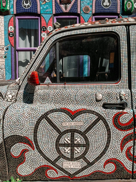 a mosaic car that is parked in front of some windows