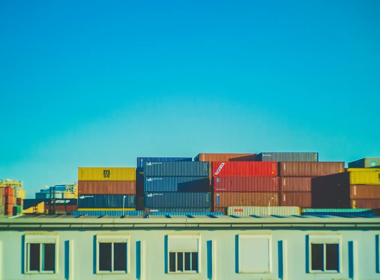 many cargo containers are stacked on top of one another