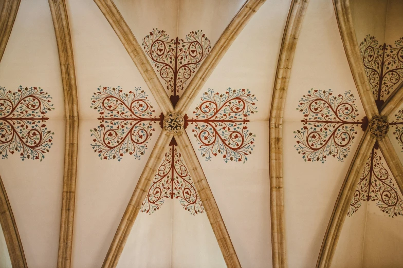 a ceiling inside of an old building with elaborate carvings