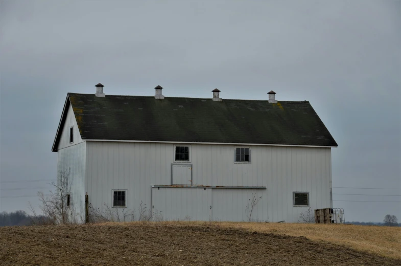 the grain silo sits outside of the farm