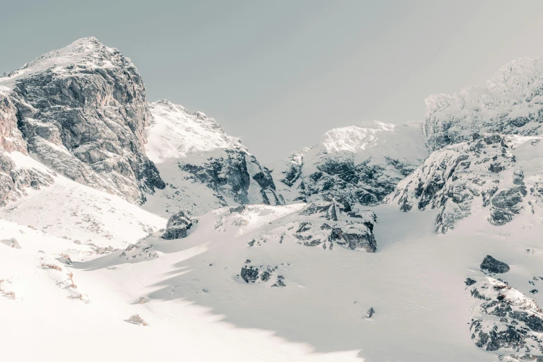 a mountain scene with trees covered in snow