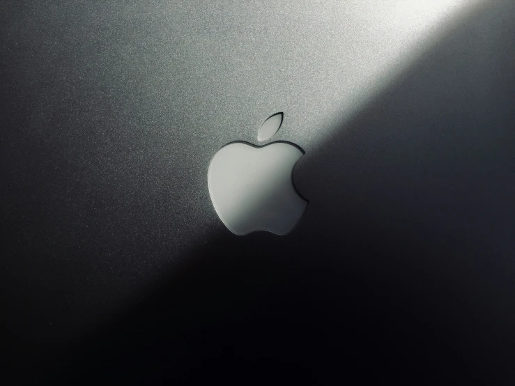 an apple computer logo is shown against the wall