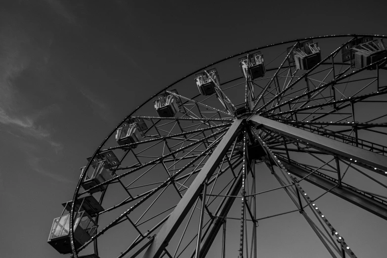 an empty ferris wheel against a blue sky