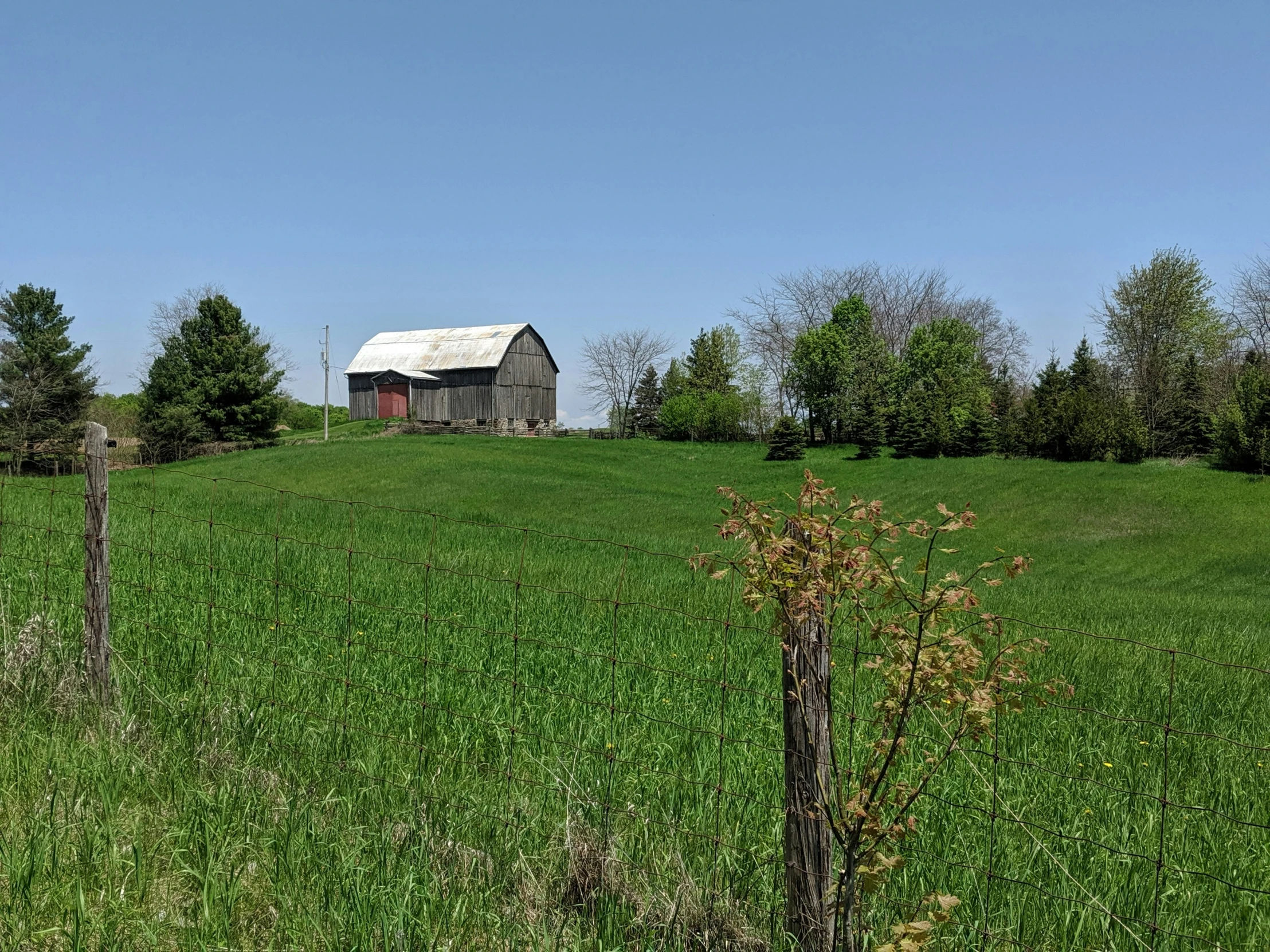 a barn and a fence in a field