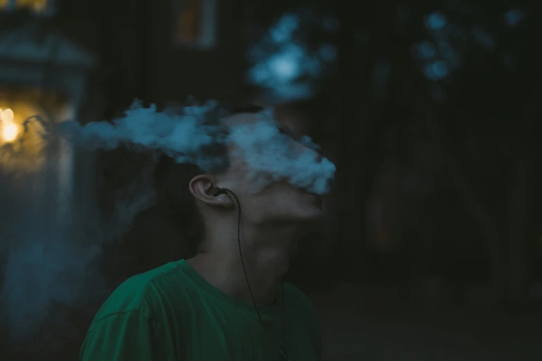 a young man smokes soing out of his ears