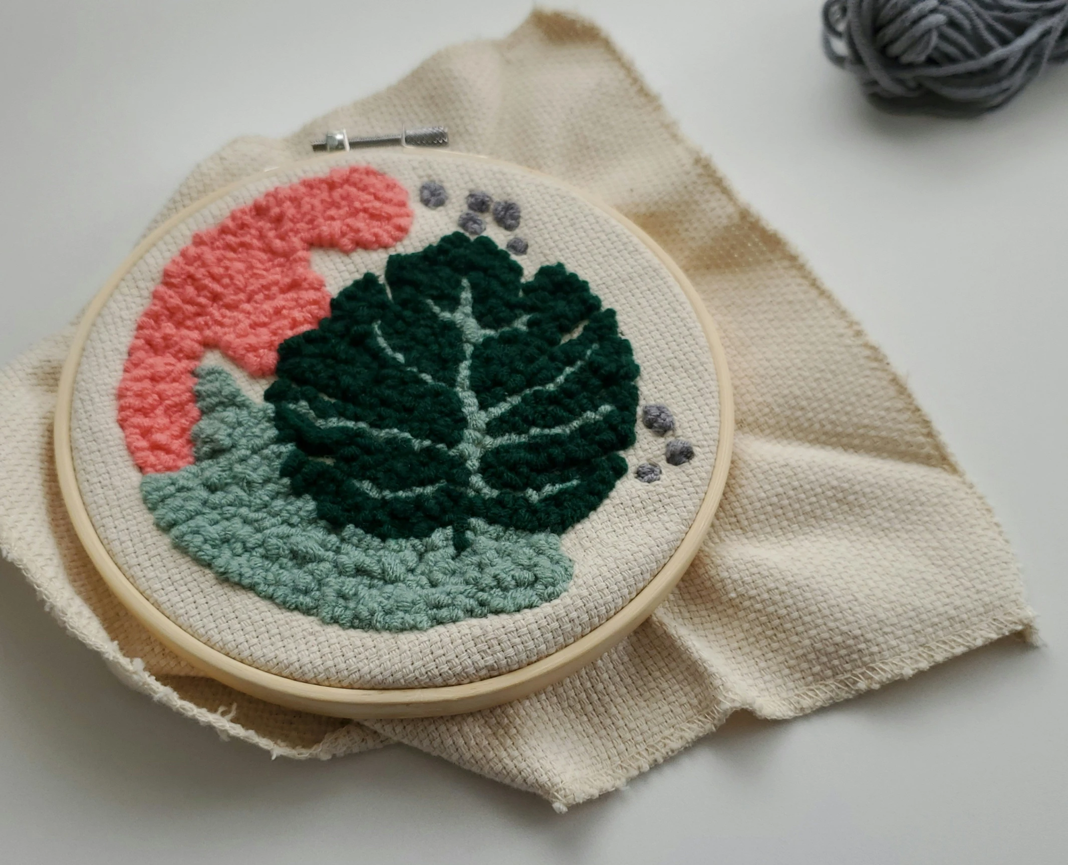 a small hand embroideryed green leaf