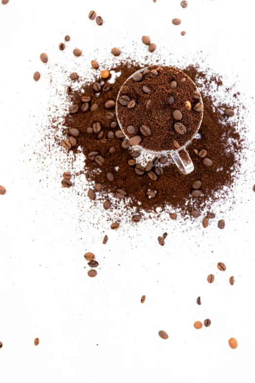 a spoon full of ground spices sitting on top of a table