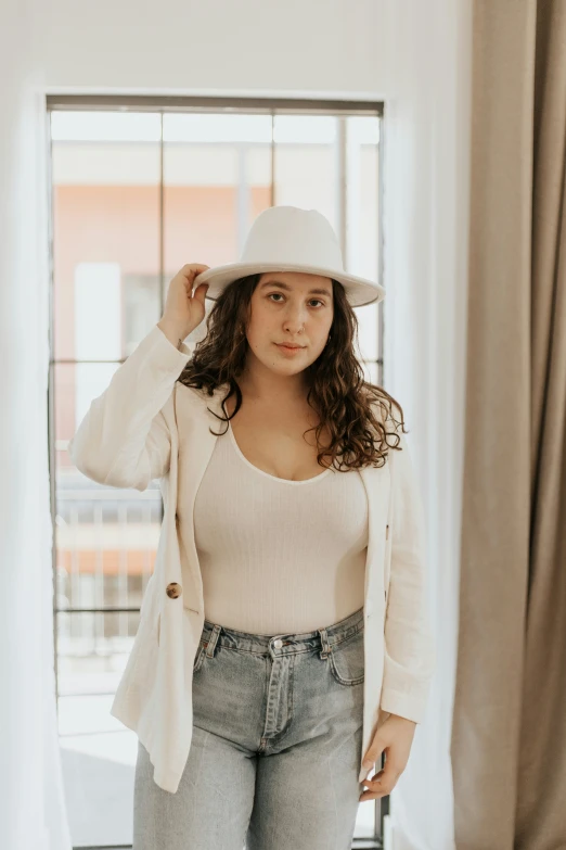 a woman in jeans and a white jacket