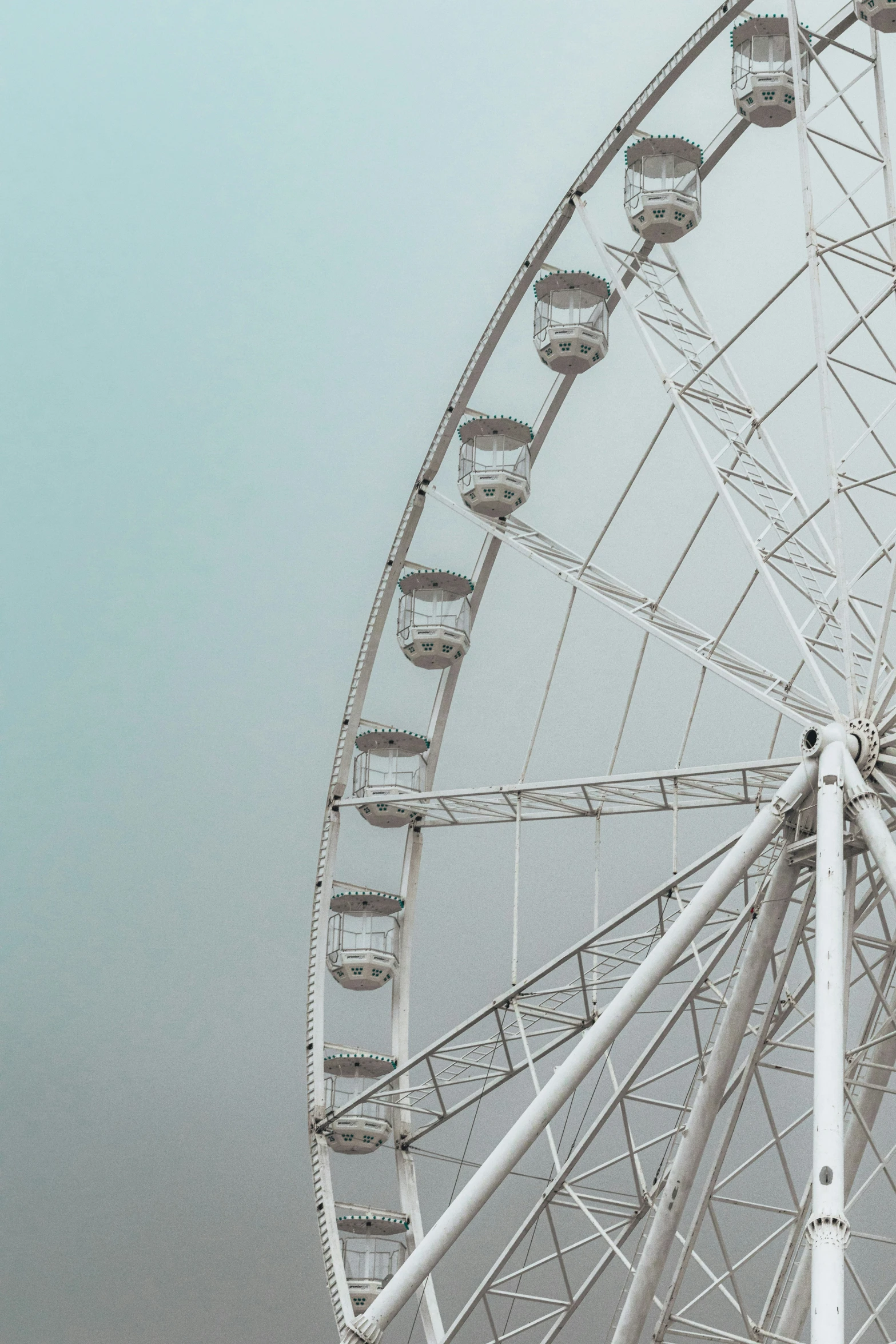 large white ferris wheel against a cloudy sky