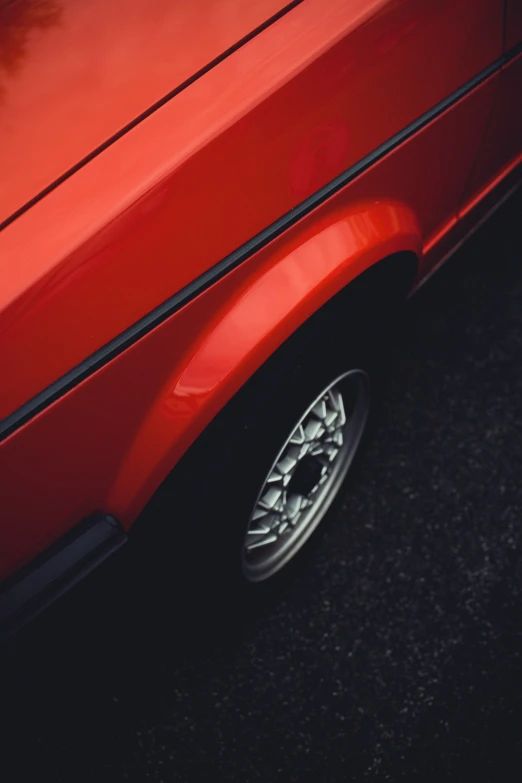 a close up of the rear wheels on a red car