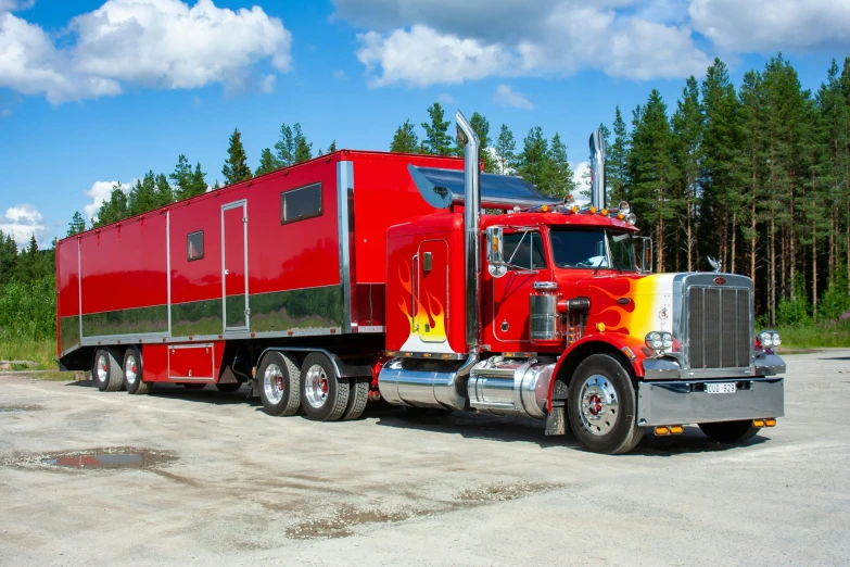 a large red and yellow truck is parked in a lot