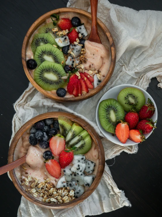 fruit topped with yogurt, granola and nuts