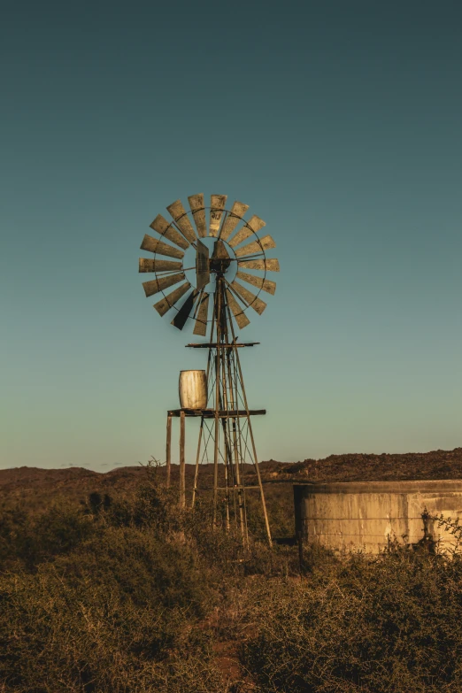 an old windmill with an old tv on it in a field