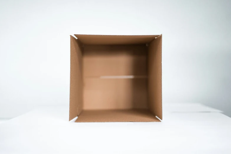 a brown box sits on a white surface