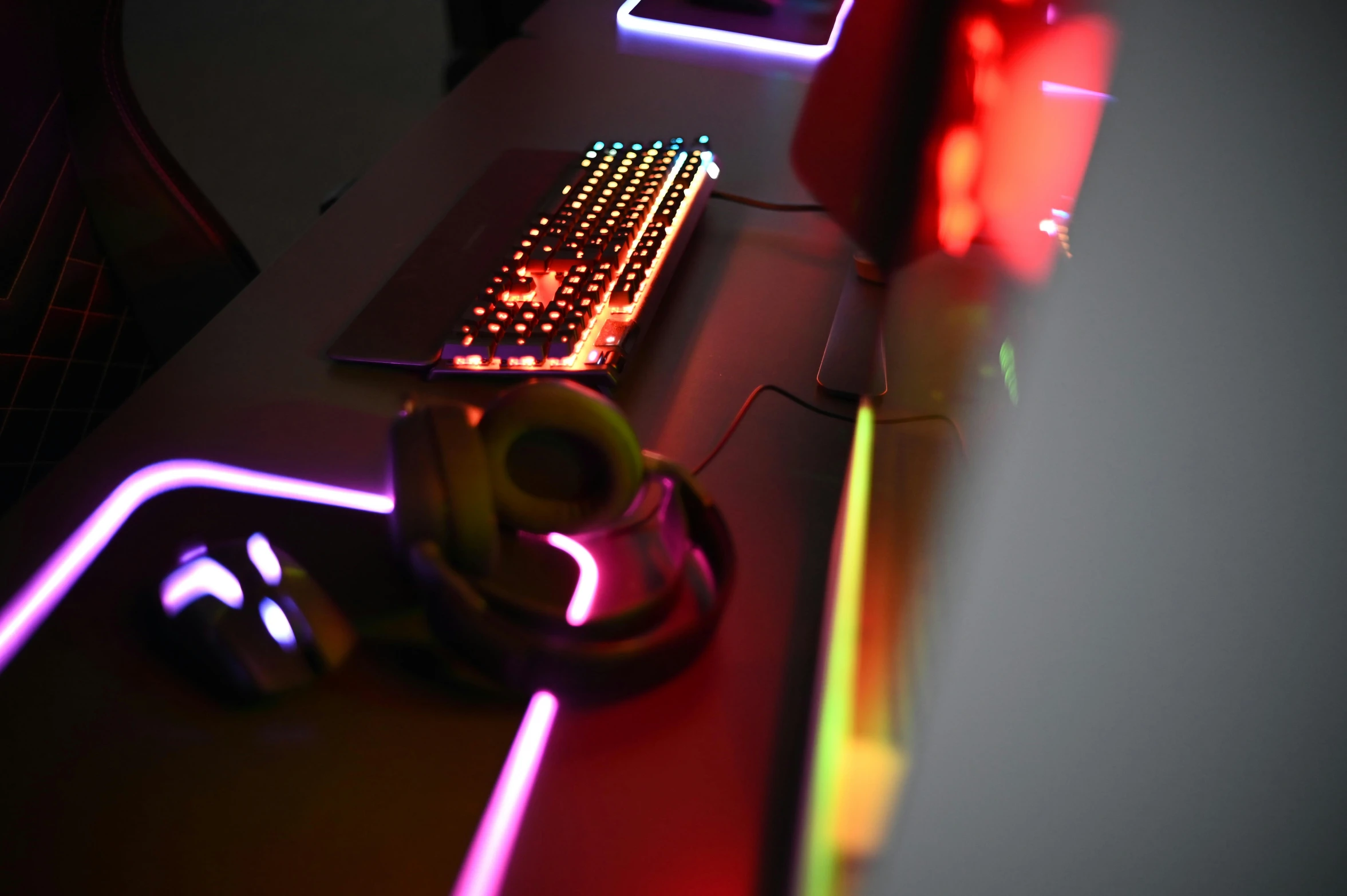 glowing computer mouse on a desk with a laptop nearby