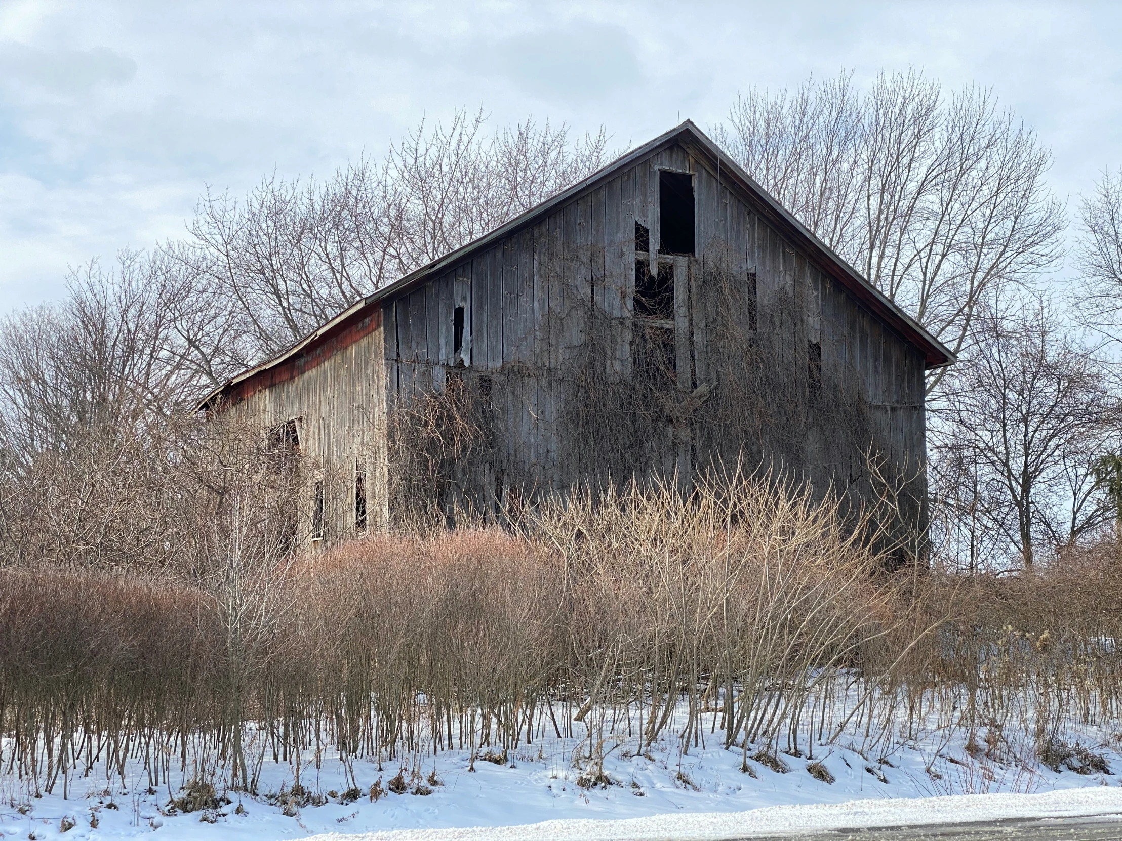 an old dilapidated building sits in the snow