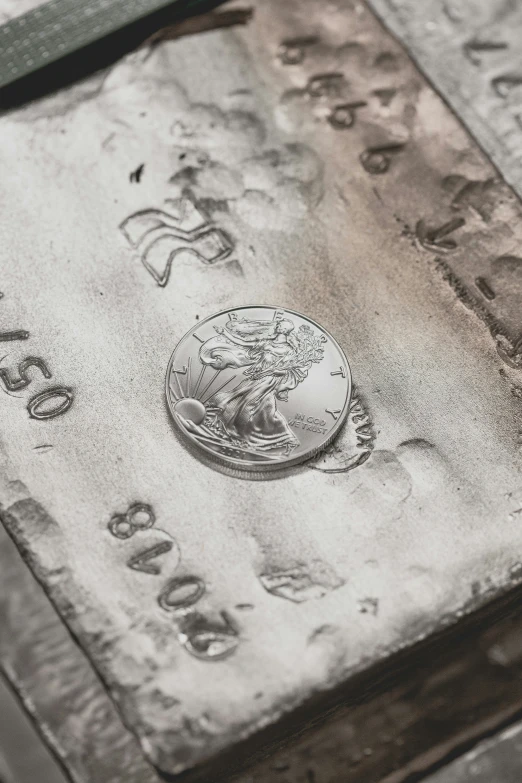 a coin sitting on top of an old rug